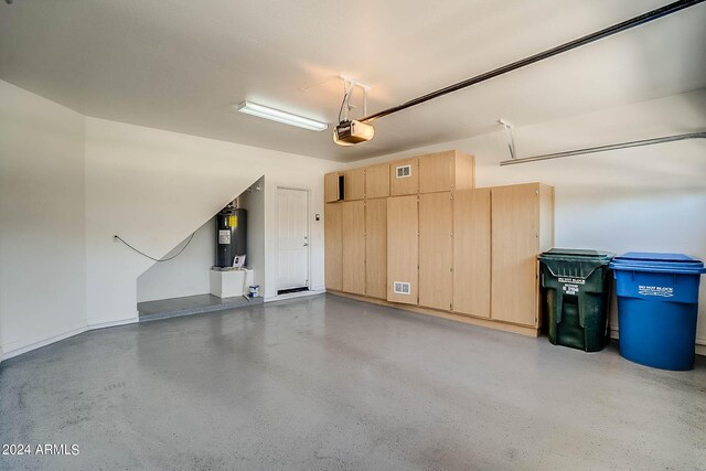 garage featuring a garage door opener and electric water heater