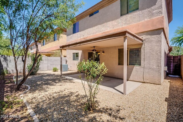 back of house with central AC, ceiling fan, and a patio