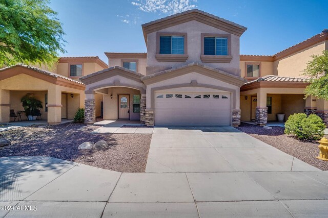 mediterranean / spanish-style home featuring a garage