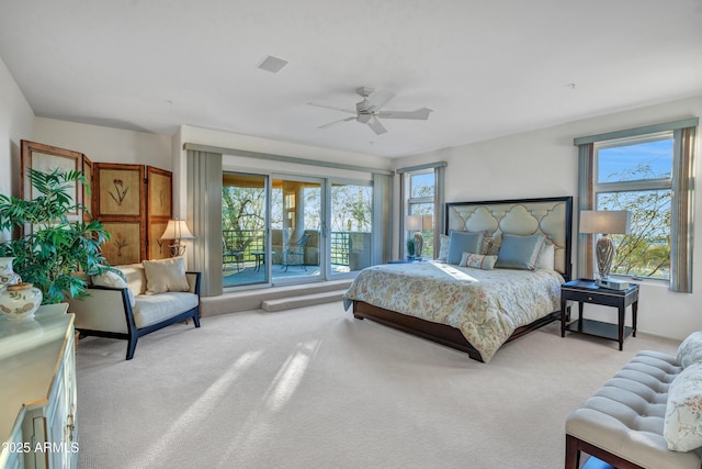 carpeted bedroom featuring multiple windows and ceiling fan