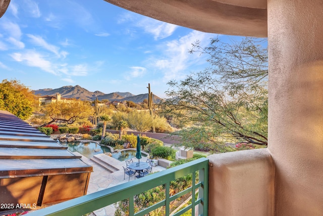 balcony with a hot tub and a mountain view