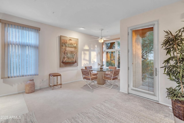 dining space featuring light carpet