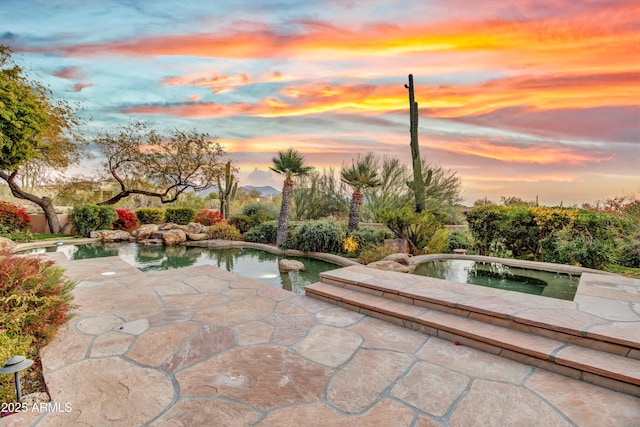 view of patio terrace at dusk