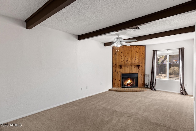 unfurnished living room with a large fireplace, beam ceiling, light carpet, and a textured ceiling