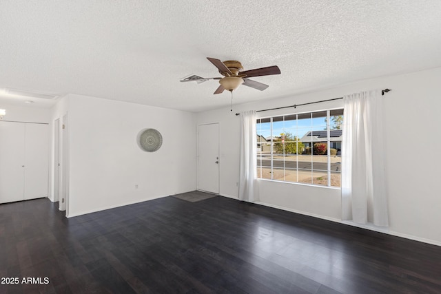 unfurnished room featuring ceiling fan, dark hardwood / wood-style floors, and a textured ceiling