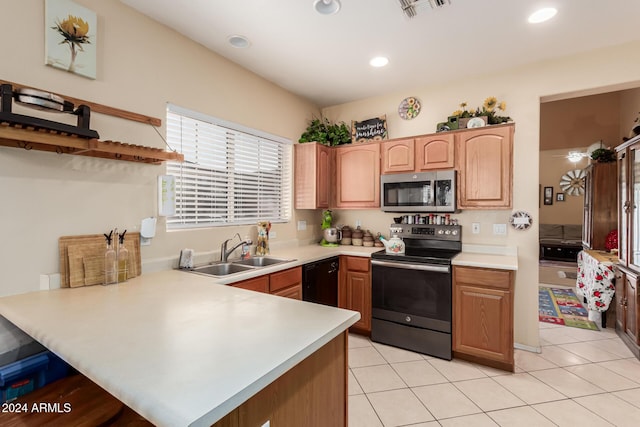 kitchen featuring kitchen peninsula, light tile patterned floors, stainless steel appliances, and sink