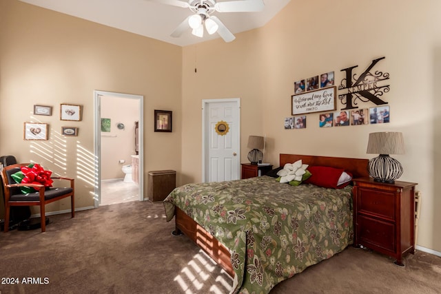 bedroom with ensuite bath, ceiling fan, carpet floors, and a high ceiling