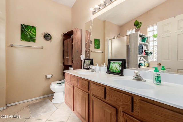 bathroom with toilet, vanity, tile patterned floors, and walk in shower