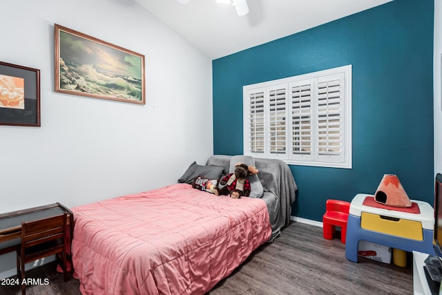 bedroom featuring hardwood / wood-style flooring, vaulted ceiling, and ceiling fan