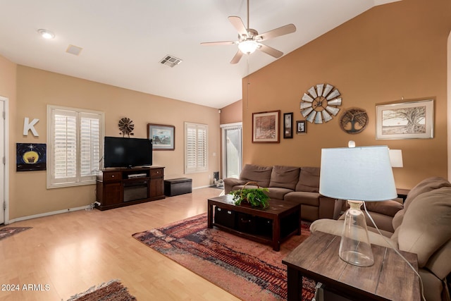 living room with light hardwood / wood-style flooring, vaulted ceiling, and ceiling fan