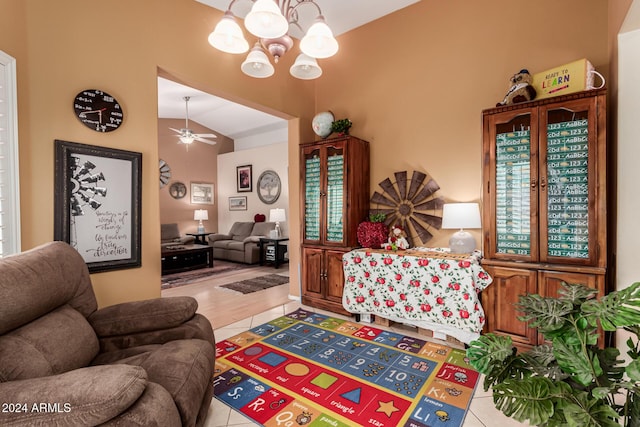 living room with ceiling fan with notable chandelier, light tile patterned floors, and vaulted ceiling