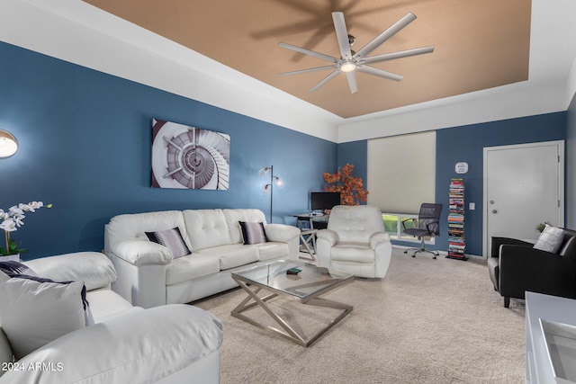 carpeted living room with ceiling fan