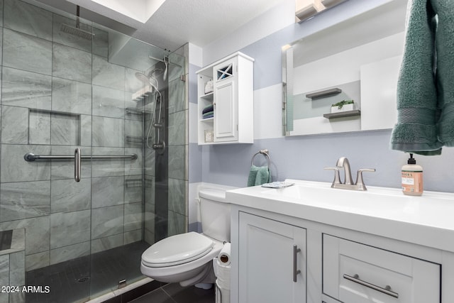 bathroom with a shower with door, vanity, and toilet