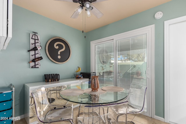 dining room with ceiling fan and tile patterned floors