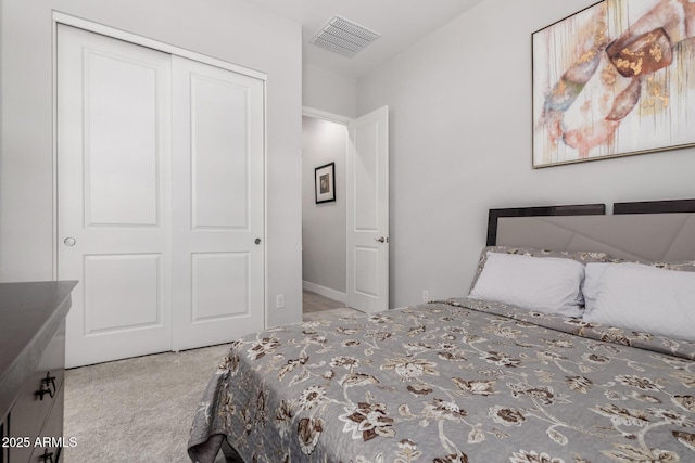 bedroom featuring light carpet and a closet