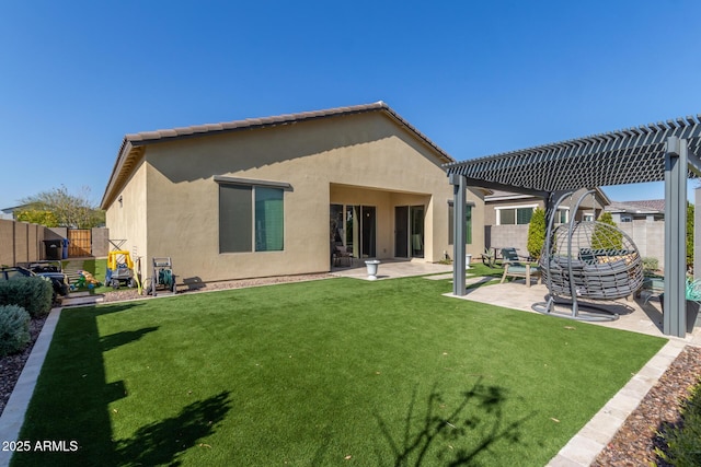 back of house featuring a pergola, a patio area, and a lawn