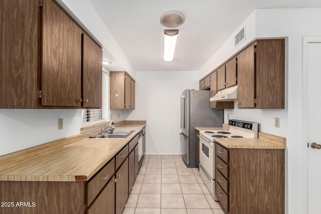 kitchen featuring sink, appliances with stainless steel finishes, and light tile patterned flooring