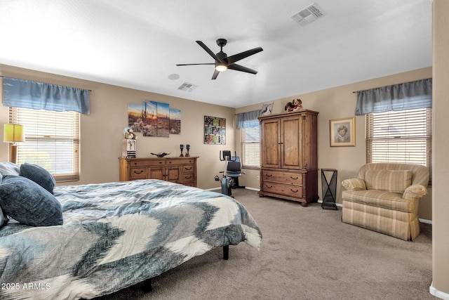 carpeted bedroom featuring multiple windows and ceiling fan