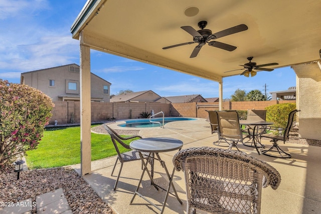 view of patio featuring a fenced in pool and ceiling fan