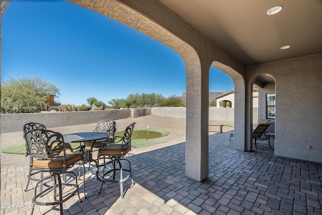 4126 S Last Chance Trl, Gold Canyon, AZ 85118 - view of patio / terrace with a putting green, a fenced backyard, and outdoor dining area