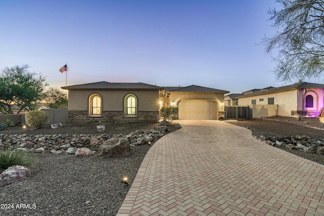 4126 S Last Chance Trl, Gold Canyon, AZ 85118 - view of front of home with stucco siding, decorative driveway, an attached garage, and fence