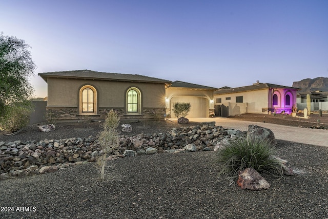 4126 S Last Chance Trl, Gold Canyon, AZ 85118 - mediterranean / spanish-style home featuring stucco siding, driveway, an attached garage, and stone siding