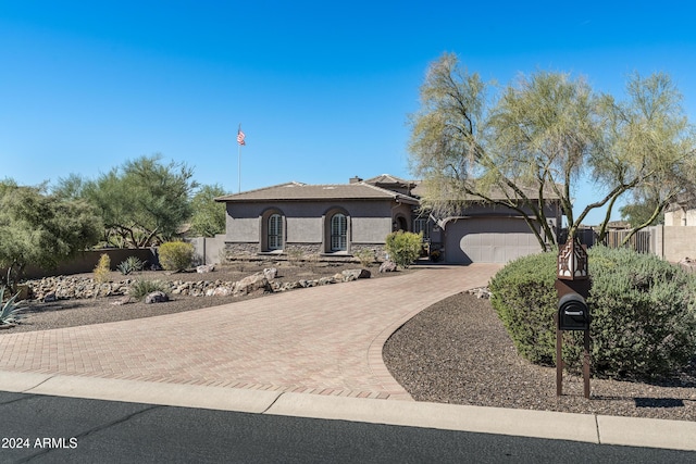 4126 S Last Chance Trl, Gold Canyon, AZ 85118 - view of front of house with stucco siding, stone siding, decorative driveway, a garage, and fence