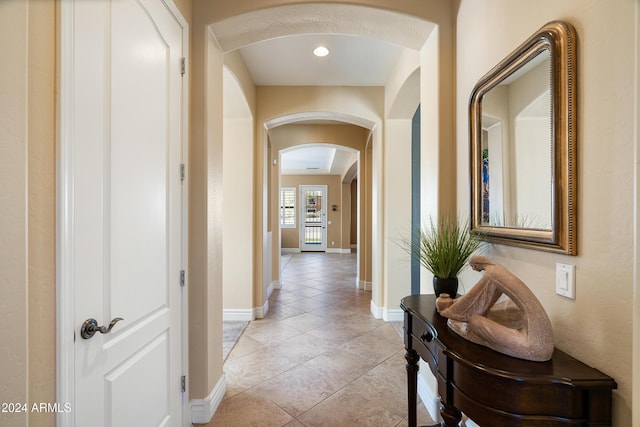 4126 S Last Chance Trl, Gold Canyon, AZ 85118 - corridor with arched walkways, light tile patterned floors, and baseboards