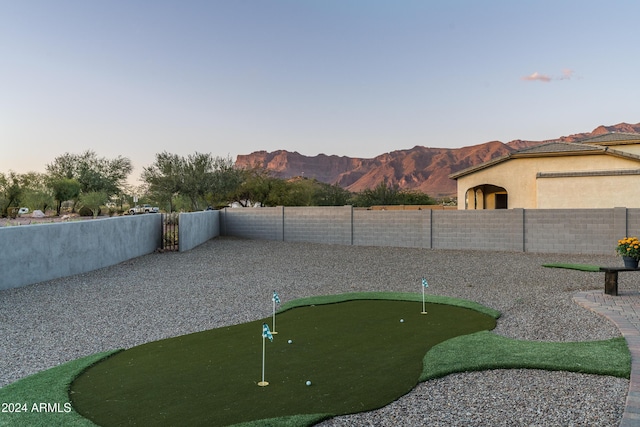4126 S Last Chance Trl, Gold Canyon, AZ 85118 - fenced backyard featuring a putting green and a mountain view