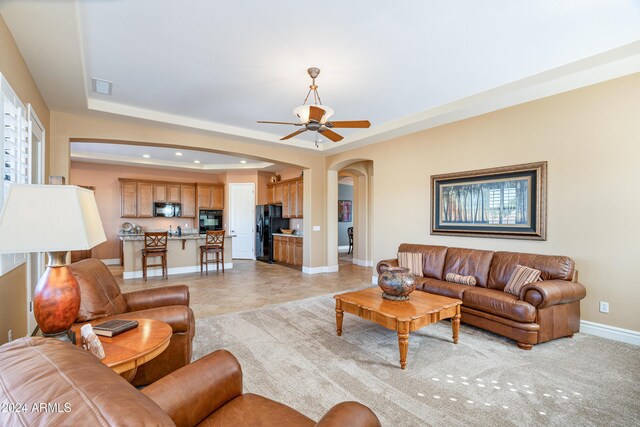 4126 S Last Chance Trl, Gold Canyon, AZ 85118 - living room featuring arched walkways, baseboards, a ceiling fan, a raised ceiling, and recessed lighting