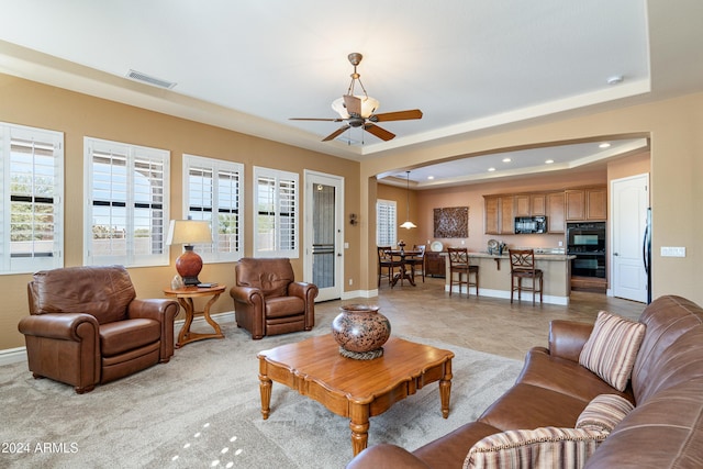4126 S Last Chance Trl, Gold Canyon, AZ 85118 - living area with baseboards, recessed lighting, a raised ceiling, arched walkways, and a ceiling fan