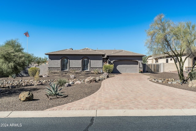 4126 S Last Chance Trl, Gold Canyon, AZ 85118 - view of front of home with stucco siding, a garage, decorative driveway, stone siding, and fence