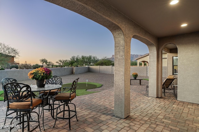4126 S Last Chance Trl, Gold Canyon, AZ 85118 - view of patio featuring a putting area, a fenced backyard, and outdoor dining area