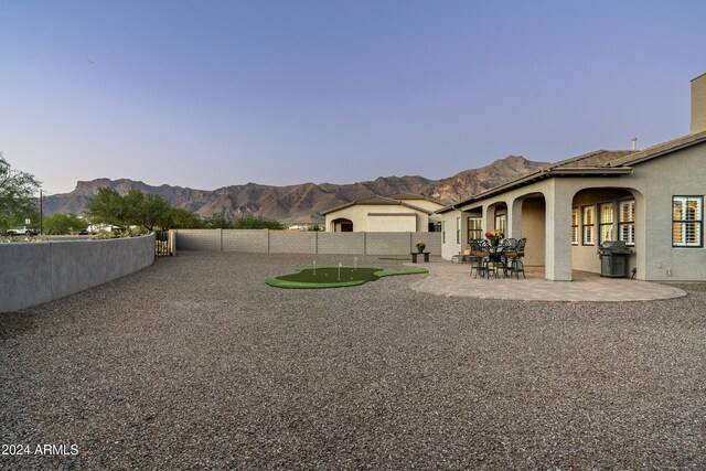 4126 S Last Chance Trl, Gold Canyon, AZ 85118 - fenced backyard featuring a mountain view, a patio, and a putting area