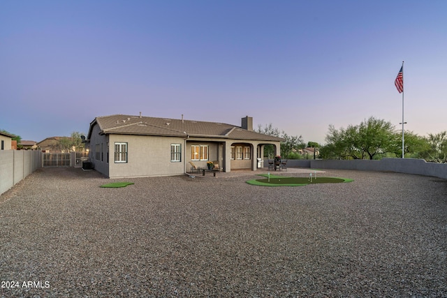 4126 S Last Chance Trl, Gold Canyon, AZ 85118 - back of property featuring a chimney, a patio, a fenced backyard, and stucco siding