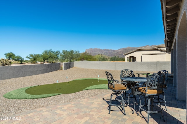 4126 S Last Chance Trl, Gold Canyon, AZ 85118 - view of patio / terrace with a putting area, a mountain view, and a fenced backyard
