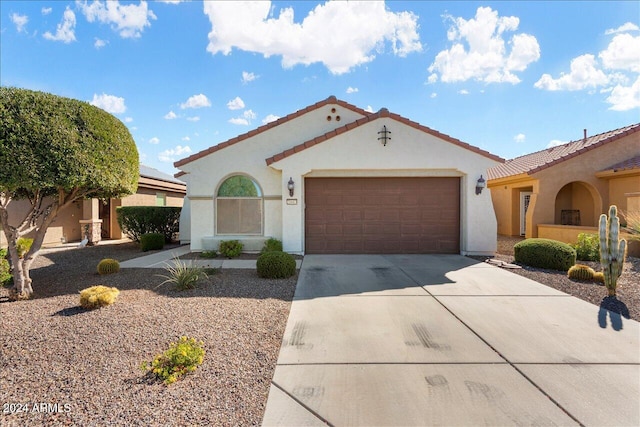 mediterranean / spanish-style home featuring a garage