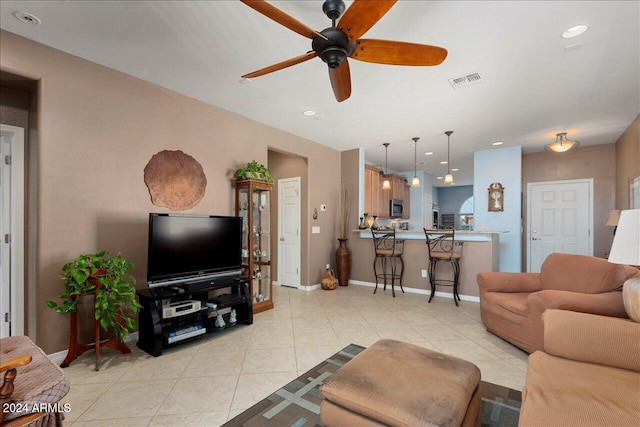 living room featuring ceiling fan and light tile patterned floors