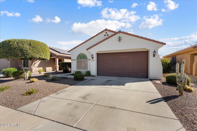 mediterranean / spanish-style home featuring a garage