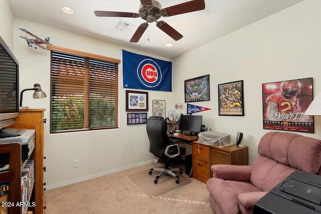 carpeted office featuring ceiling fan