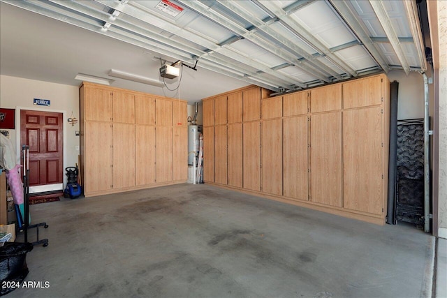 garage featuring water heater and a garage door opener