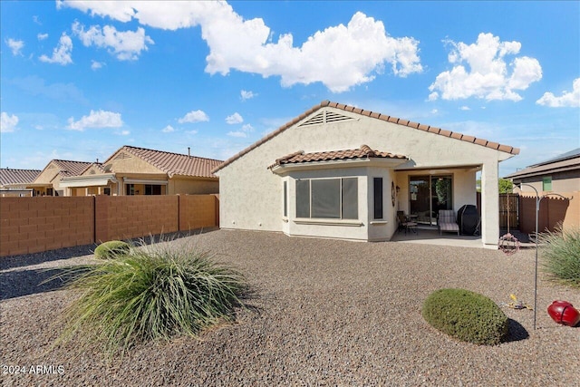 back of house with a patio