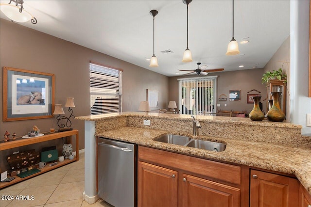 kitchen with light stone counters, sink, stainless steel dishwasher, ceiling fan, and decorative light fixtures