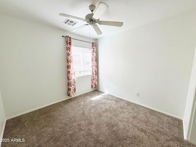spare room featuring ceiling fan, baseboards, carpet, and visible vents