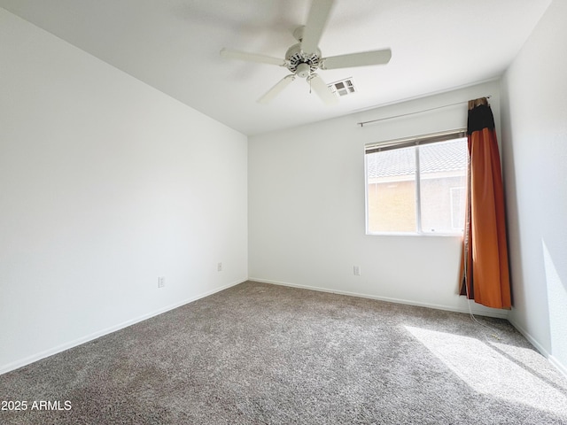 carpeted empty room featuring baseboards, a ceiling fan, and visible vents