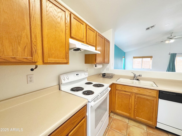 kitchen featuring white appliances, visible vents, under cabinet range hood, a sink, and lofted ceiling