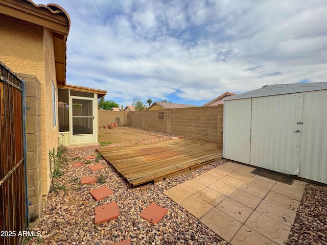 exterior space featuring a storage shed, a patio, a fenced backyard, and an outdoor structure