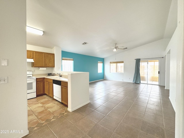 kitchen featuring open floor plan, a wealth of natural light, white appliances, and a sink
