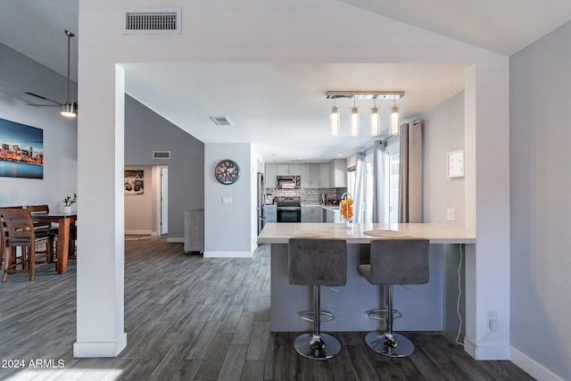 kitchen with stainless steel appliances, light countertops, visible vents, and backsplash