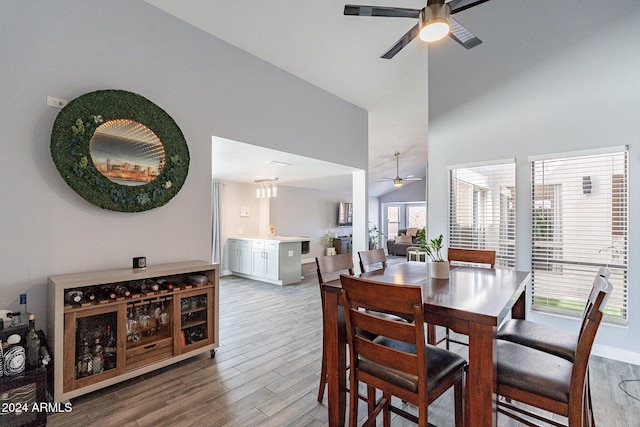 dining room featuring lofted ceiling, ceiling fan, and wood finished floors